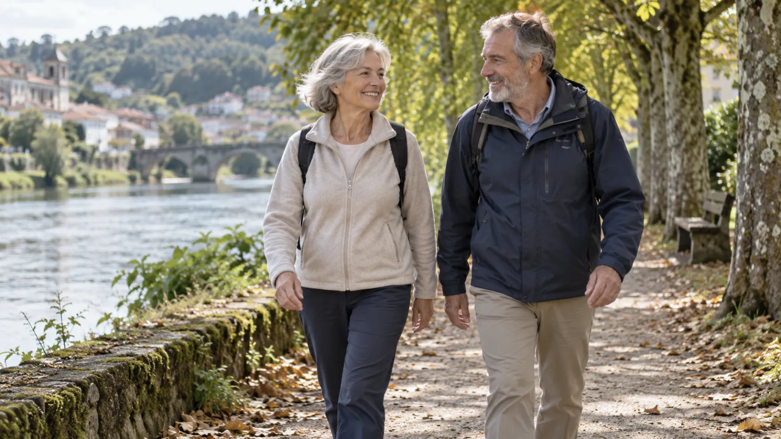 Een oudere man en vrouw wandelen samen langs een rivier
